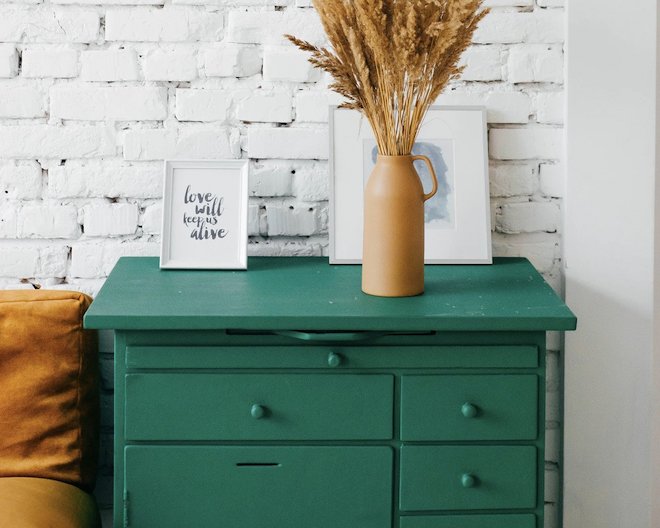 Check of drawers with a vase and photo frames on top